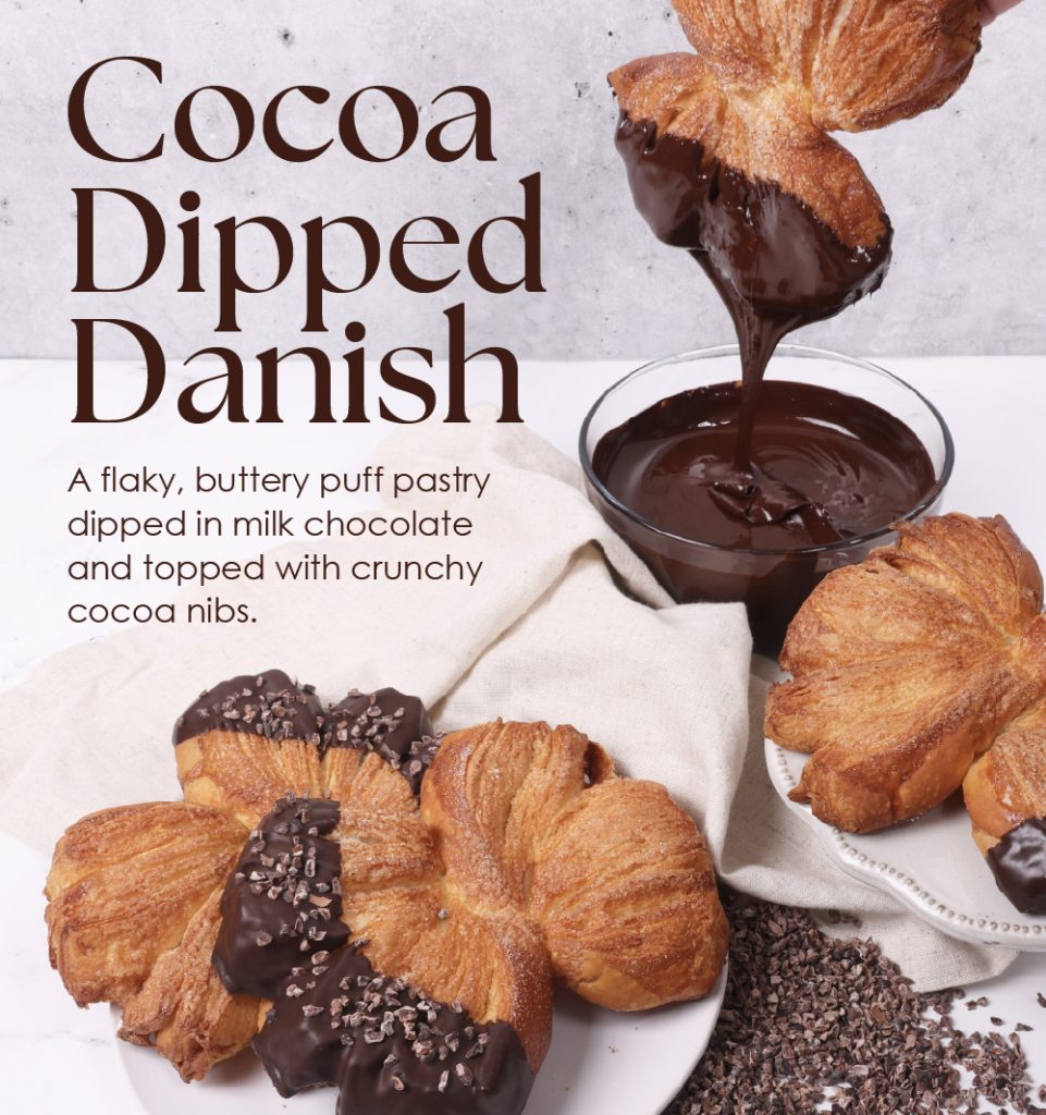 Cocoa Dipped Danish | A flaky, buttery puff pastry dipped in milk chocolate and topped with crunchy cocoa nibs.